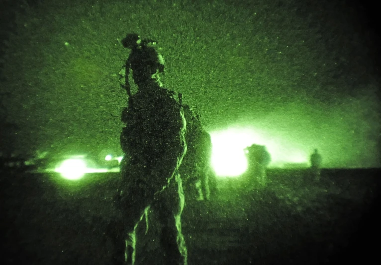 a green image shows a silhouette of a soldier and two others