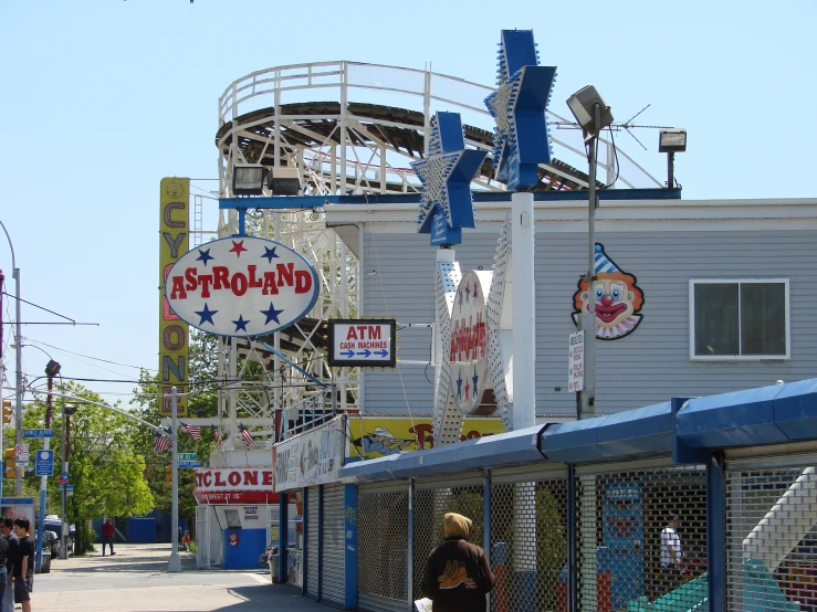 people walking along side the boardwalk near the boardwalk house