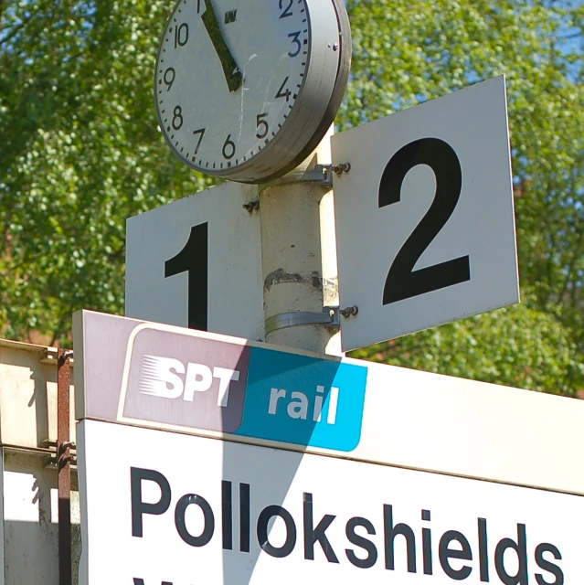 a clock that is attached to a pole