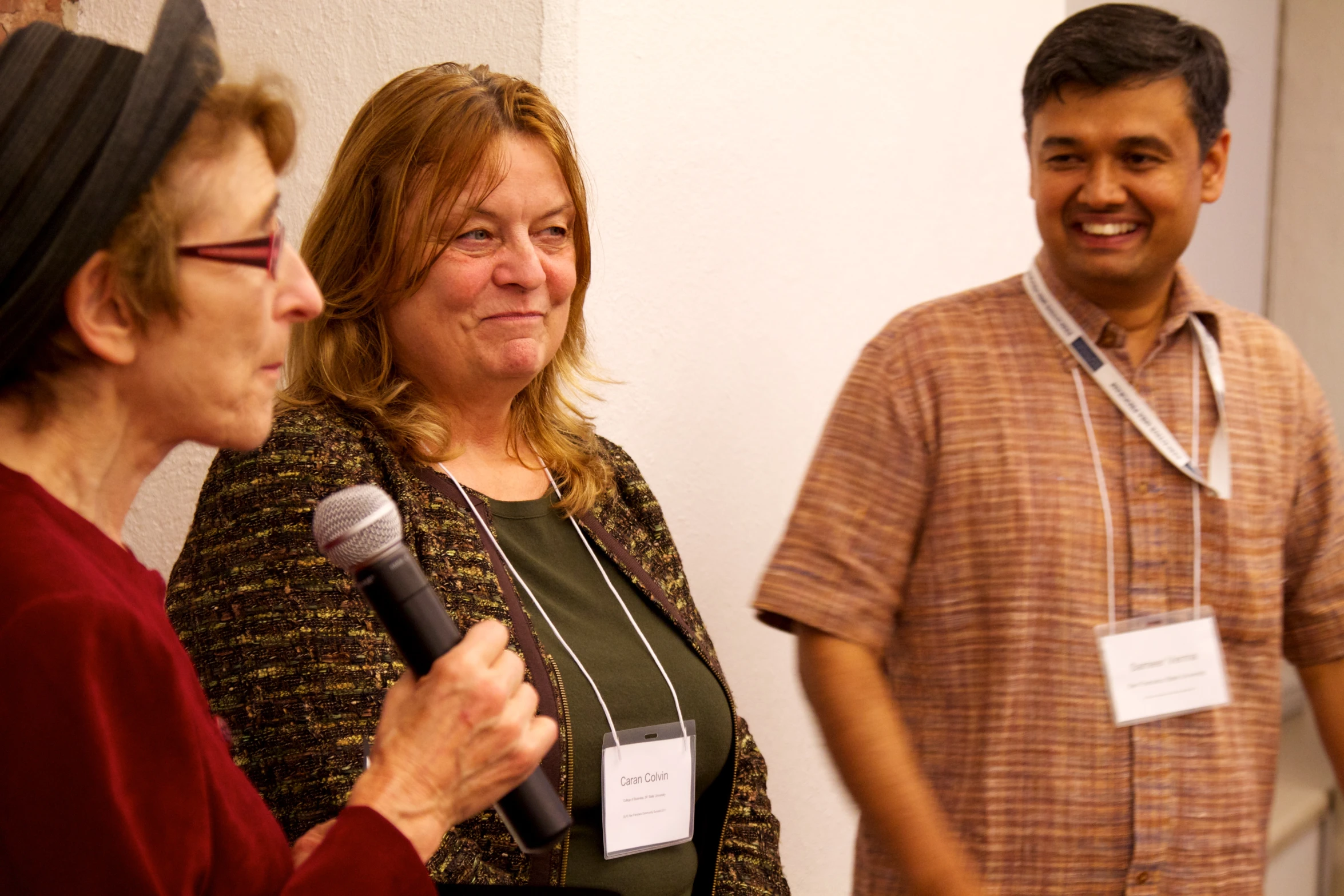 three people who are standing near each other