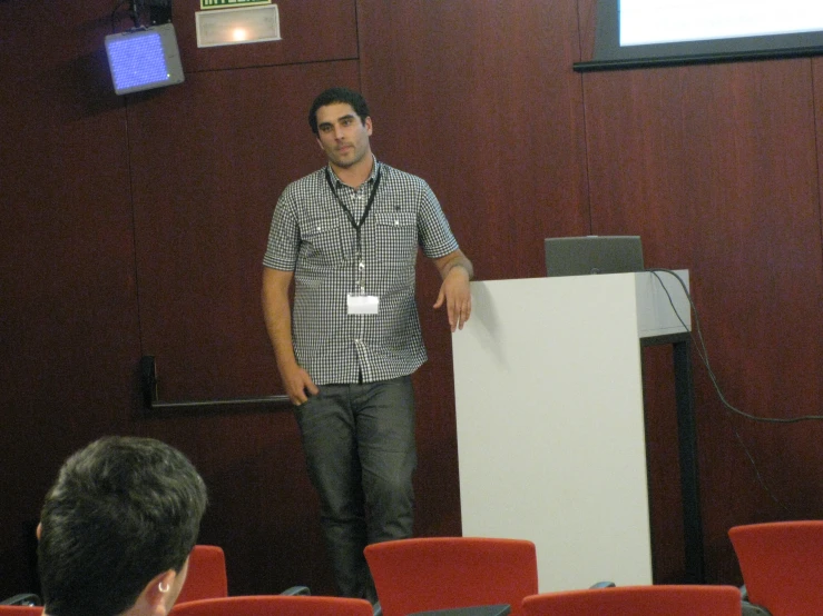 a man standing at the front of a large room