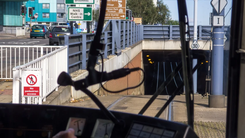 view from inside the vehicle looking at the street