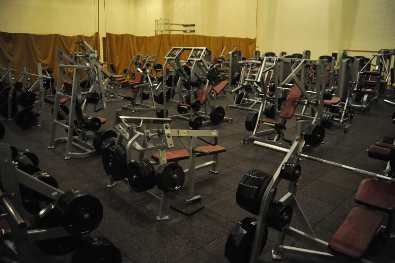 there are some rows of gym equipment in this building