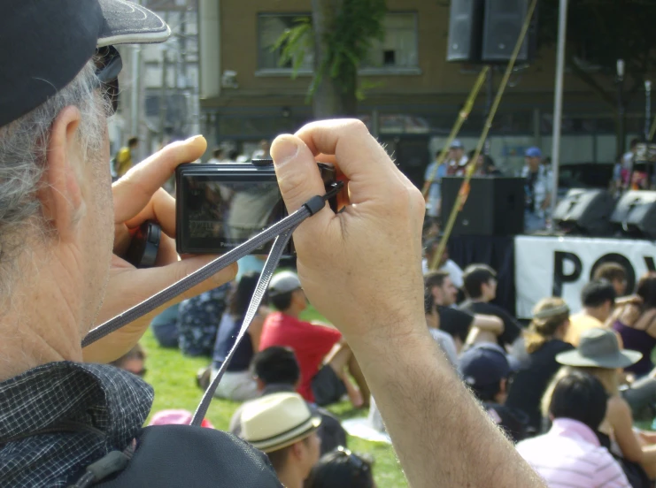 a man holding a smart phone and taking a picture