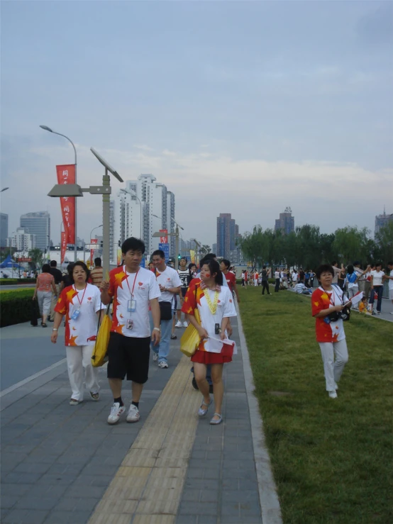 several young people wearing costumes walk along the walkway