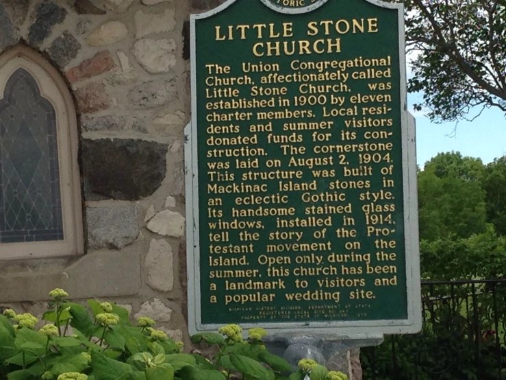 the little stone church sign has a green color