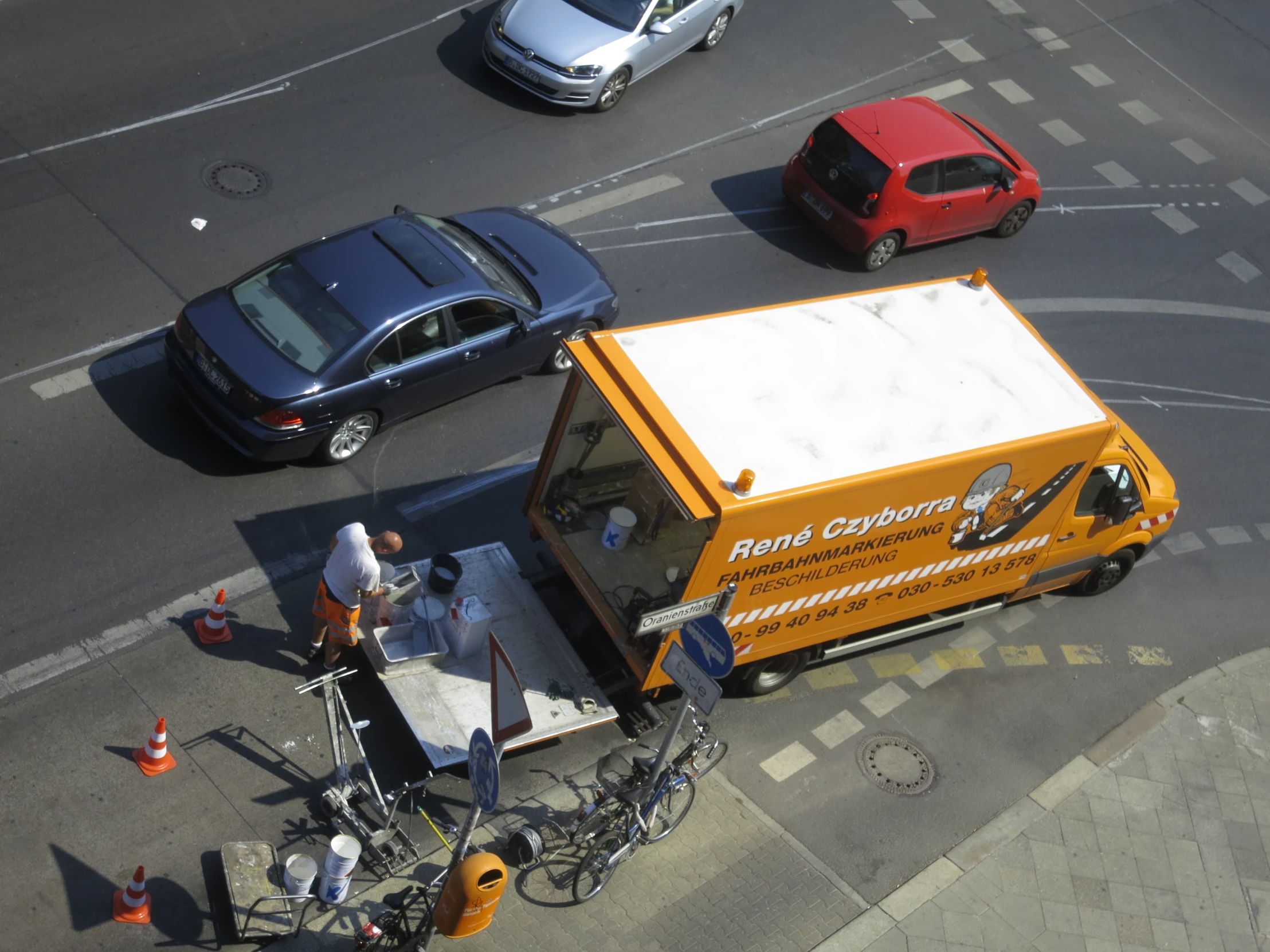 a street scene with cars and a food truck