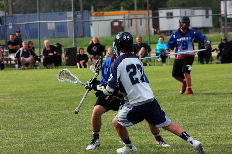 a group of people playing a game of lacrosse