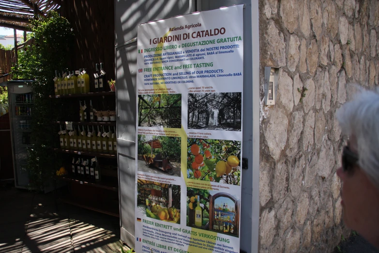 a poster on the side of a stone building in a country