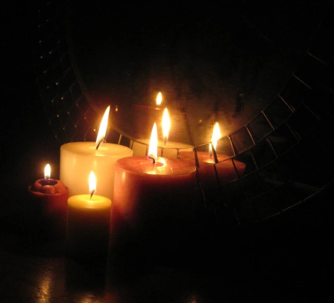 a close up of candles in the dark