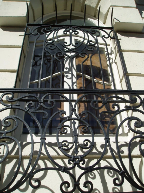 an iron grille has a door and window in it