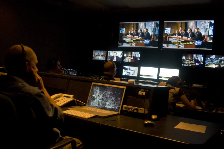 there are many people sitting in a conference room