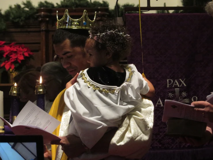 two people holding hands, and a crown are over their heads