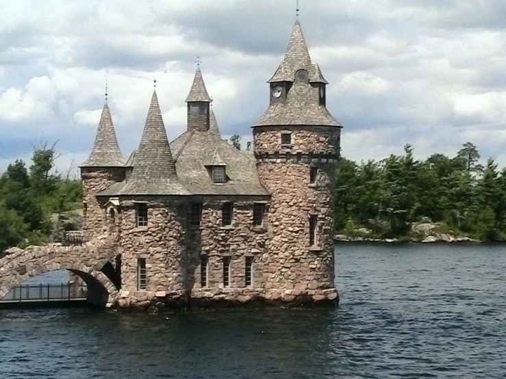 a small stone castle on a body of water