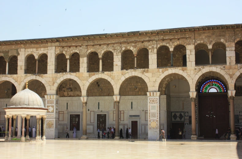 a building with arches and doors on the side of it