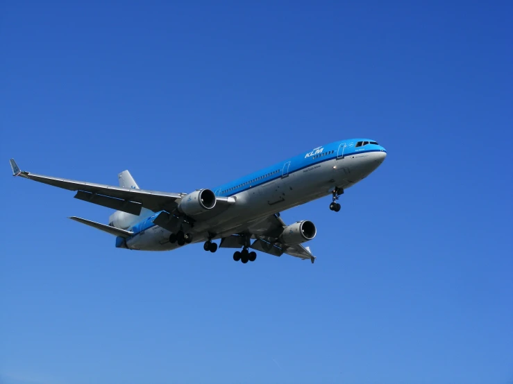 an airplane is flying against the blue sky