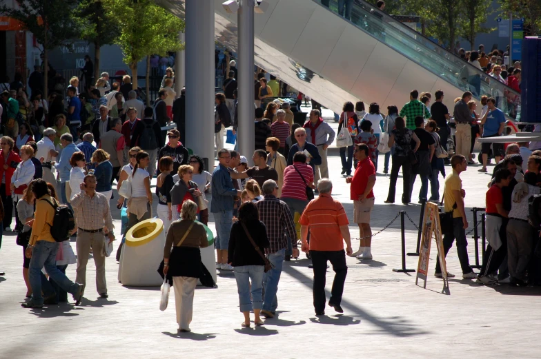 large group of people walking through a city street