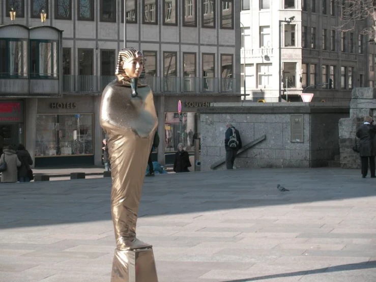 a statue is displayed in front of buildings