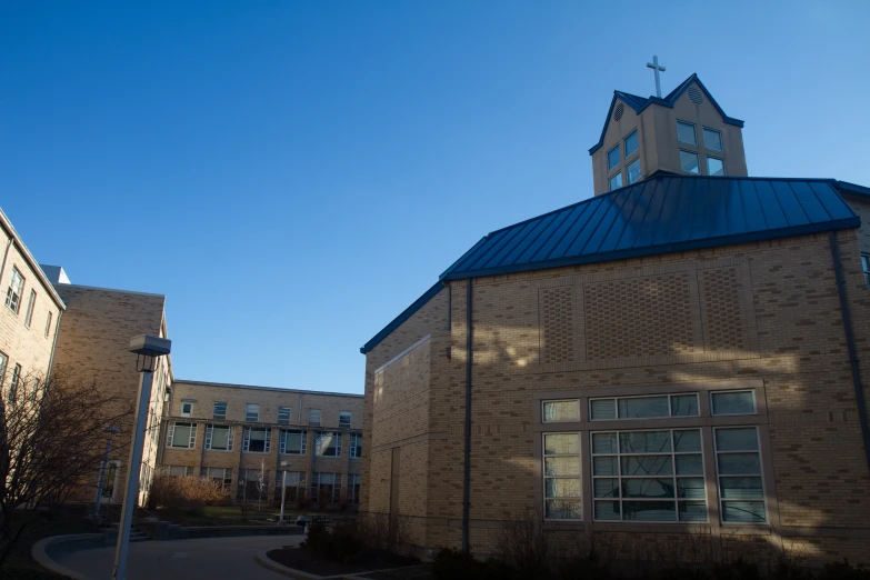 the back side of a brick building with a clock on top