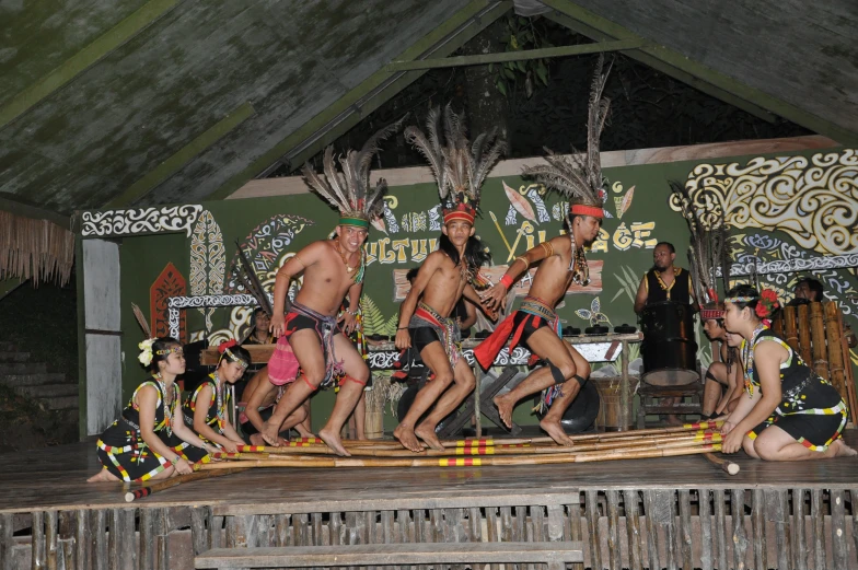 two groups of men on stage with wooden rafts