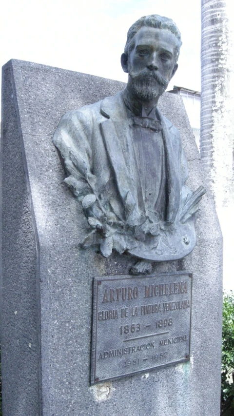 a cement statue with a plaque next to it