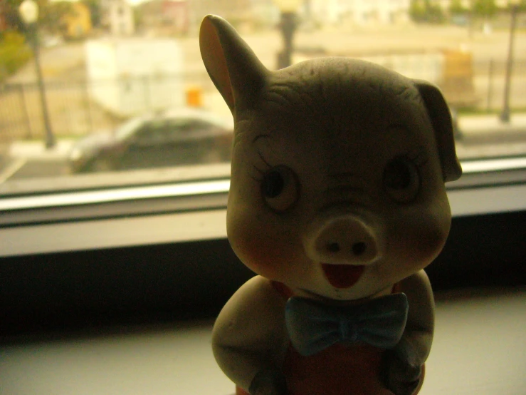 toy animal in a bow tie near window