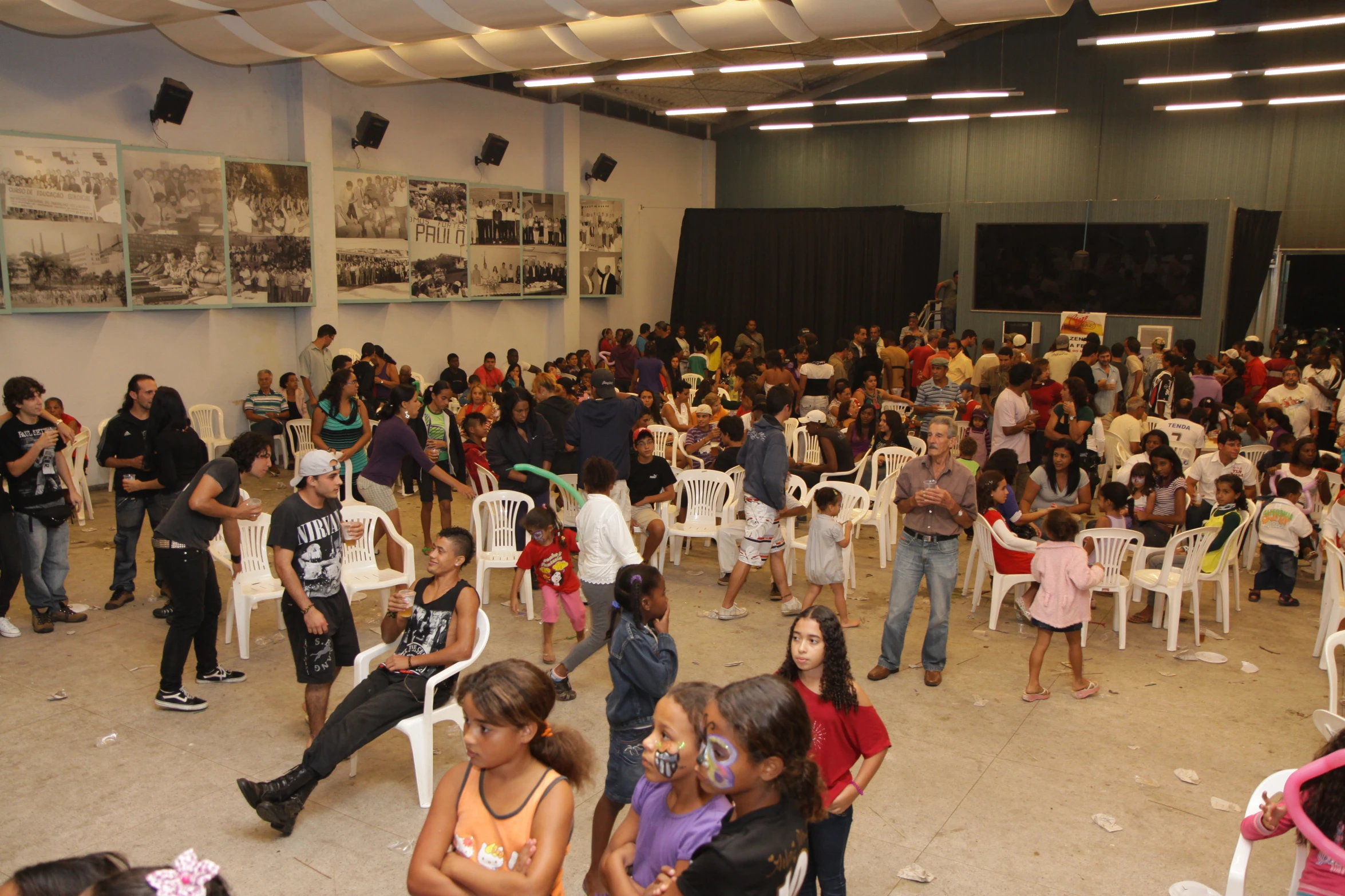 a group of people with children in a large room