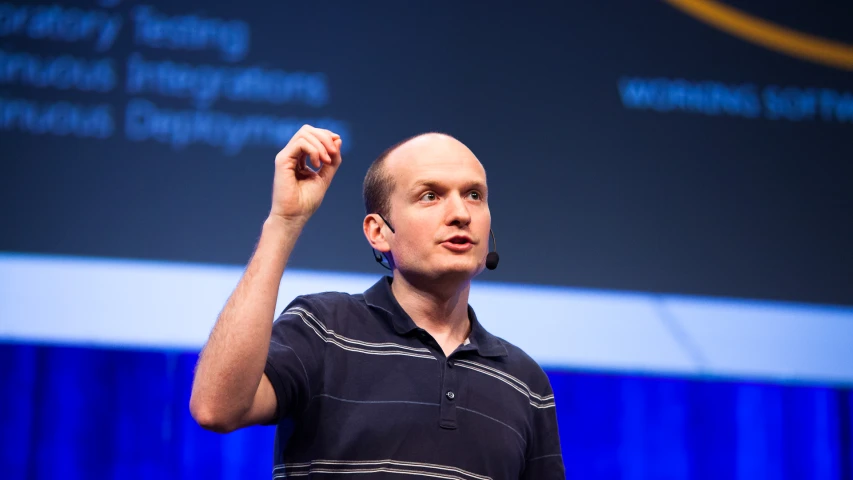 the man with an emacient look is giving a presentation