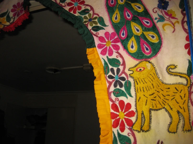 a yellow dog on a multi colored fabric curtain