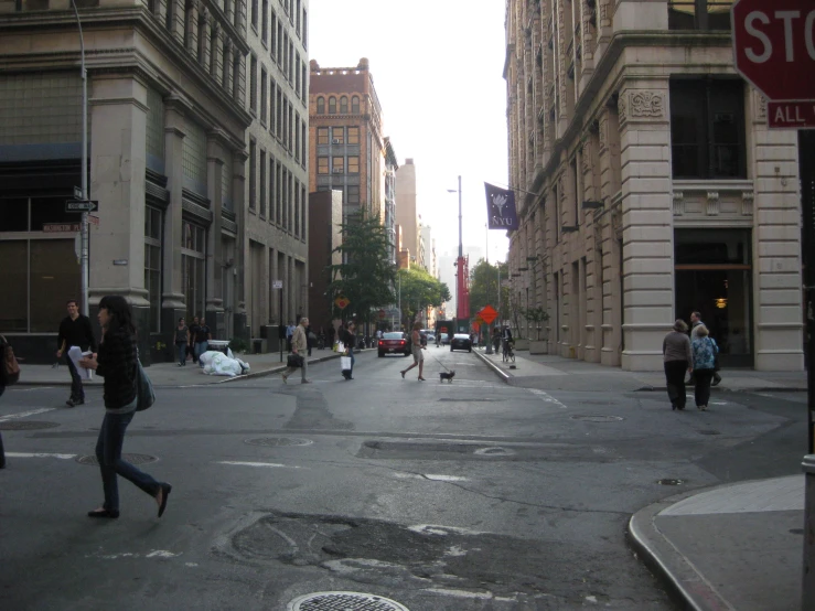 a street with people walking and walking on the sidewalk