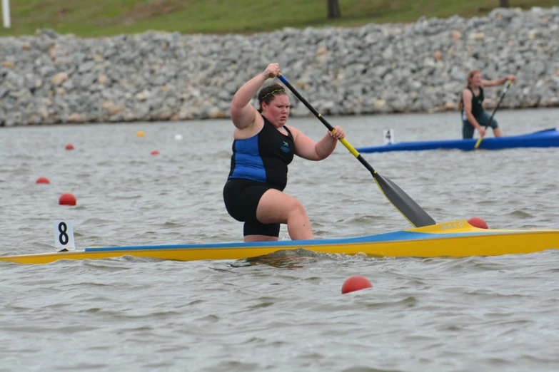 there are two woman rowing on the water