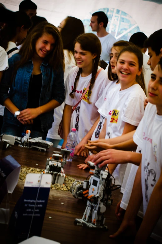 the people are looking at a robot on display