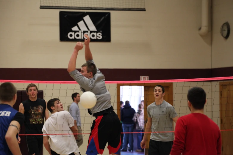 volley ball player jumps in the air to block