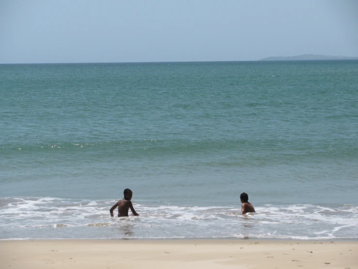 two people are wading in the ocean together