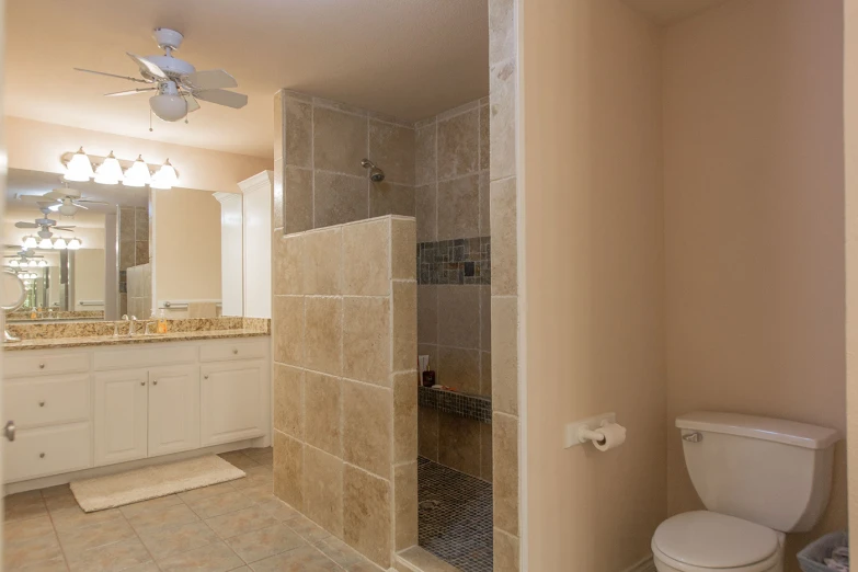 this is a bathroom with a white toilet and a glass shower