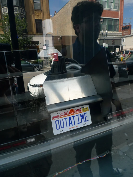 reflection of a man in a window looking at his food