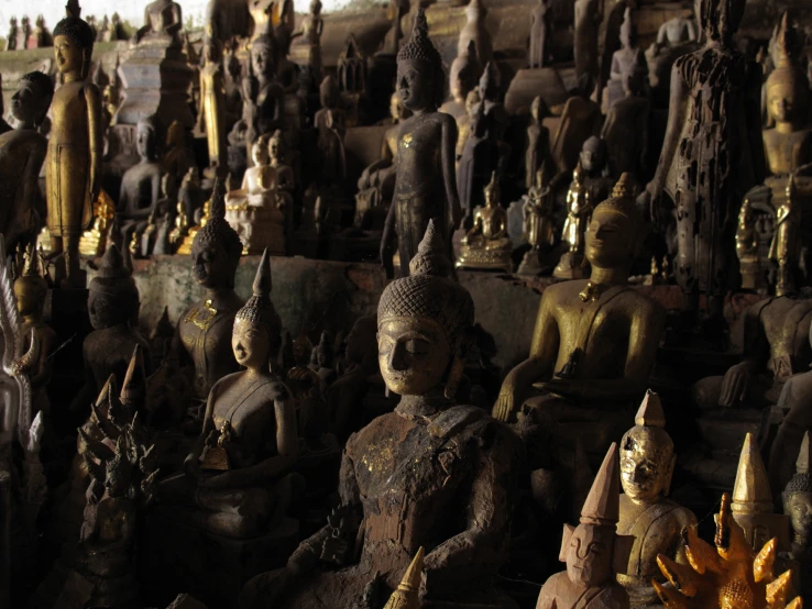 a large amount of buddha statues on display