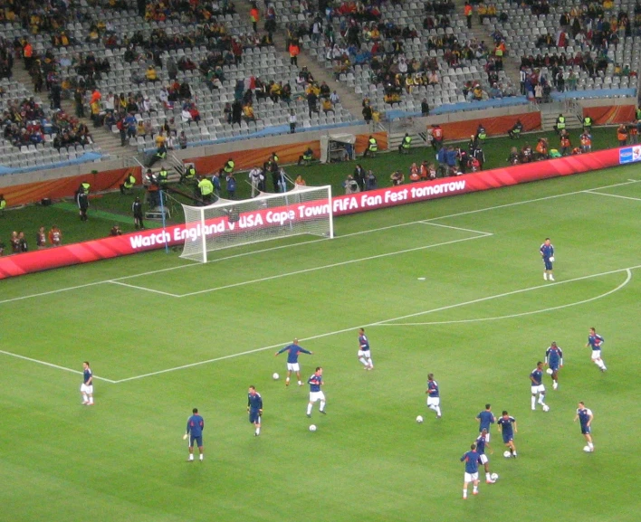 soccer players are on a field in front of fans