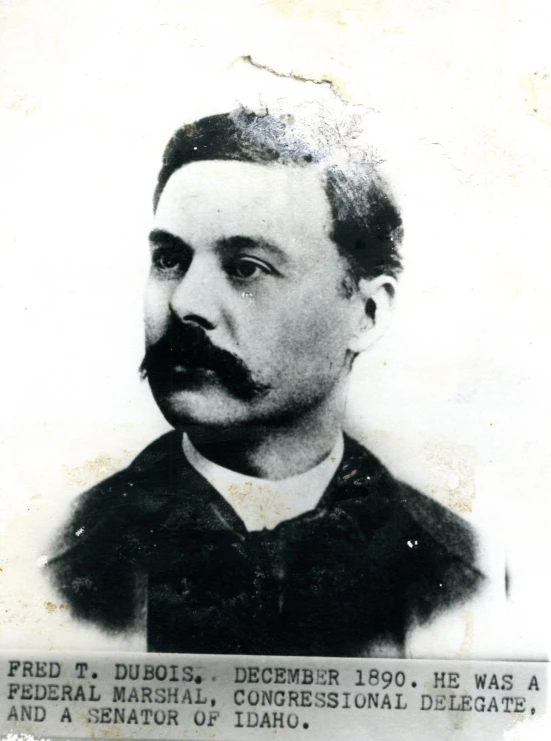 a black and white picture of a man with mustaches