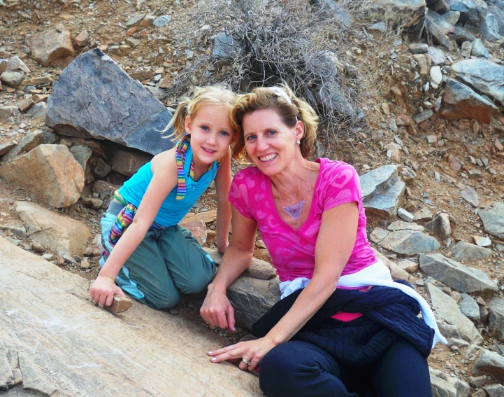 the young woman is posing for a po beside her older daughter