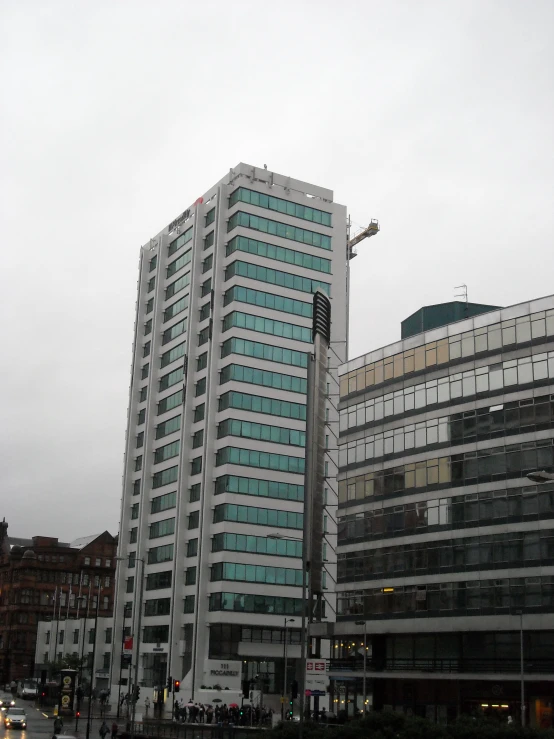 two tall buildings with windows are seen on a street