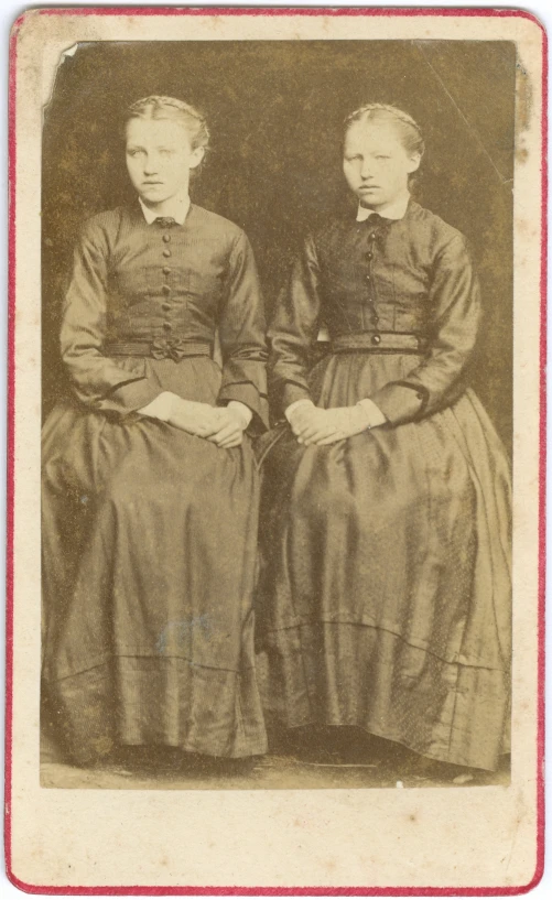 two women in dress pose for a portrait