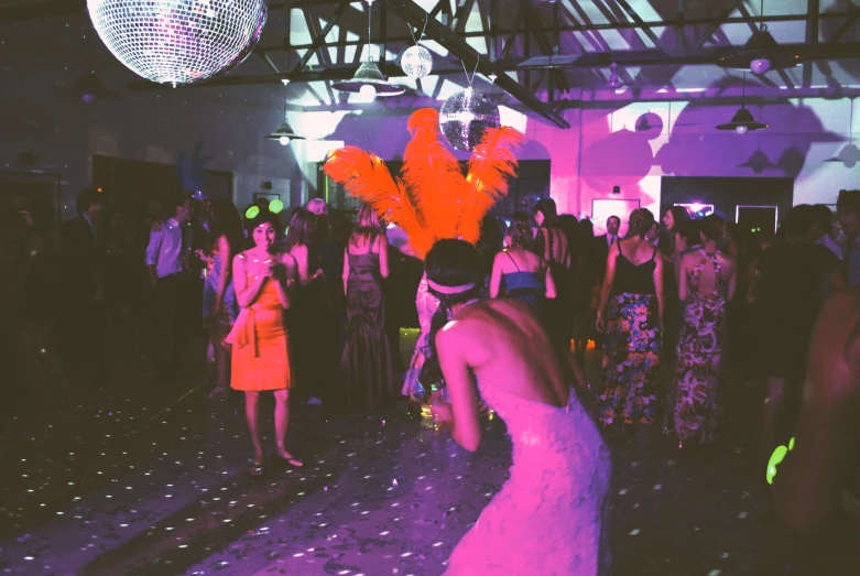 a woman with an orange head piece on at a party