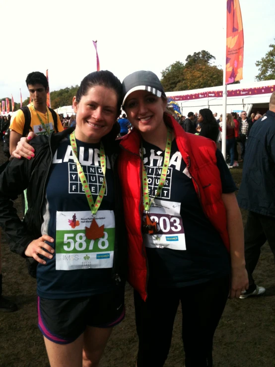 two women in running gear are posing for the camera