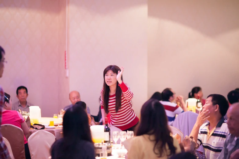 a woman that is standing up in front of a table