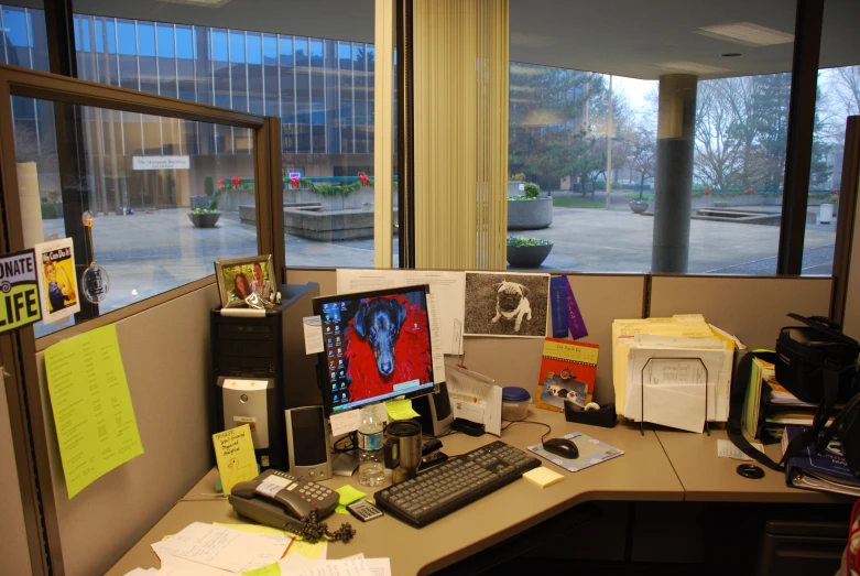 this desk contains two computers, a mailer, and a notepad