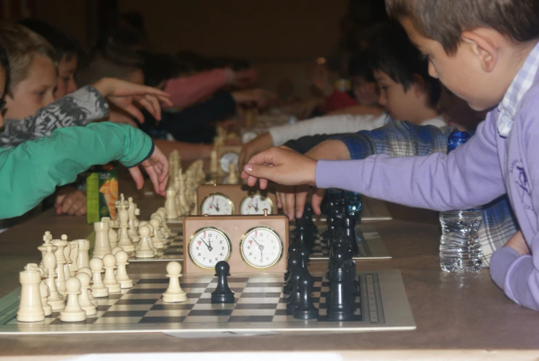 s playing a board game with many pieces