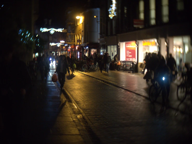 a group of people riding bikes down a street