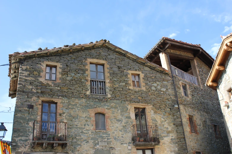 the building is made of stone and has several windows