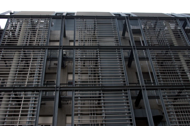 a large metal structure in front of a building